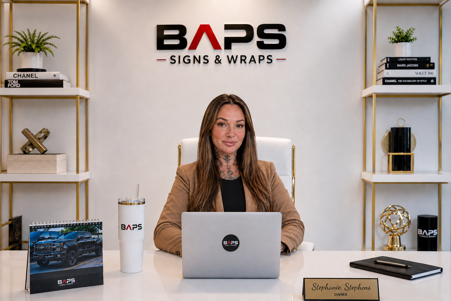 Stephanie Stephens, founder and owner of BAPS Signs & Wraps, at her desk in Oldsmar, FL